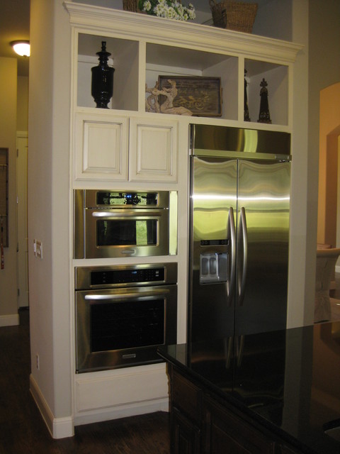 wall ovens next to refrigerator in kitchen by Burrows 