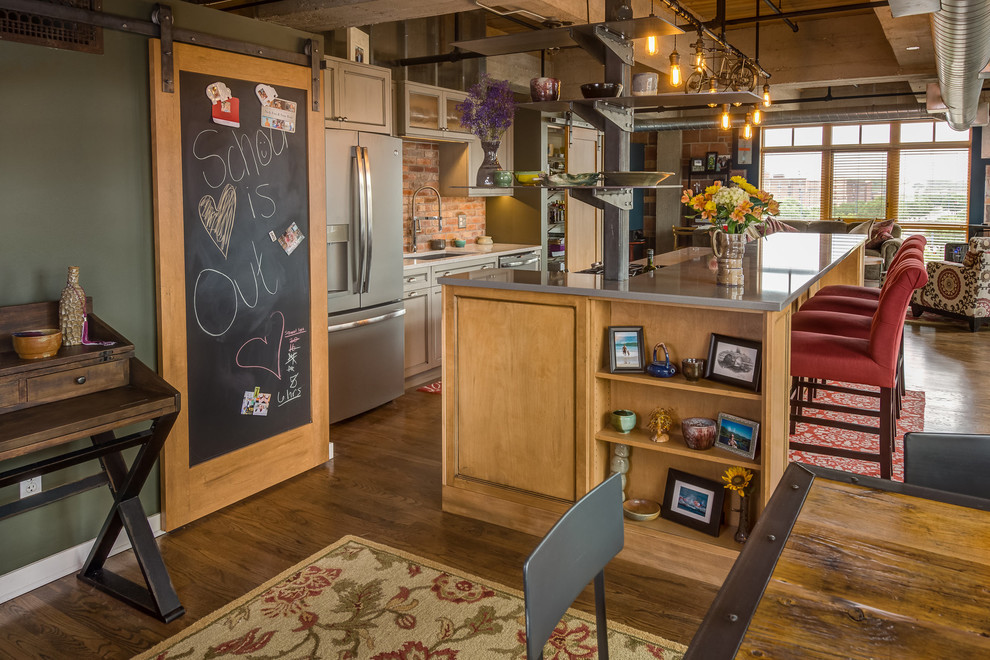 Large mountain style single-wall medium tone wood floor and brown floor open concept kitchen photo with an undermount sink, shaker cabinets, gray cabinets, quartz countertops, red backsplash, brick backsplash, an island and gray countertops
