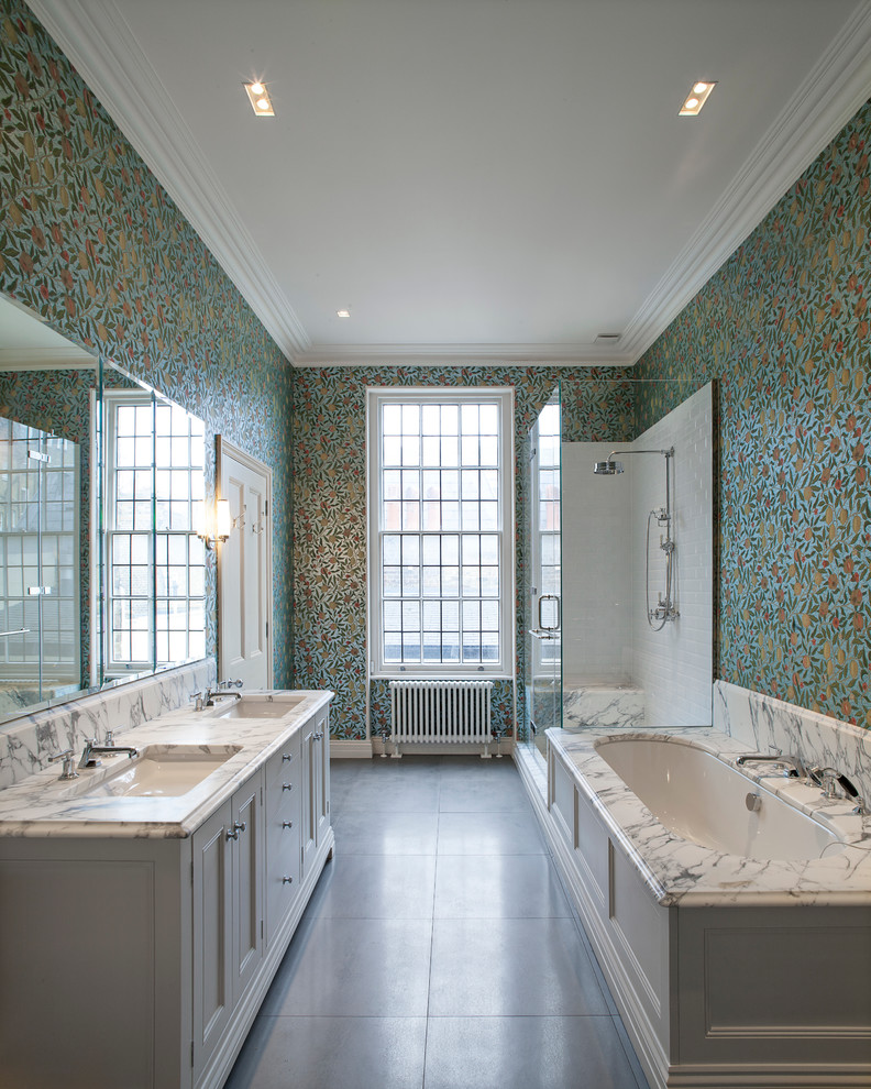 Inspiration for a traditional master bathroom in London with an undermount sink, recessed-panel cabinets, white cabinets, an undermount tub, a corner shower, multi-coloured walls and marble benchtops.