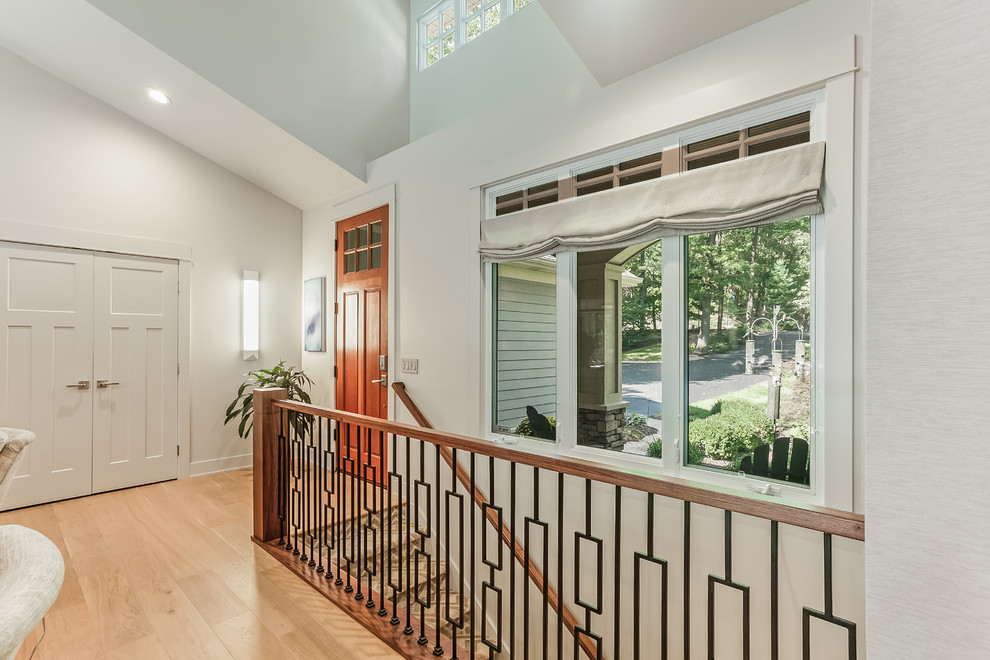 Mid-sized contemporary foyer in Grand Rapids with white walls, light hardwood floors, a single front door, an orange front door and yellow floor.