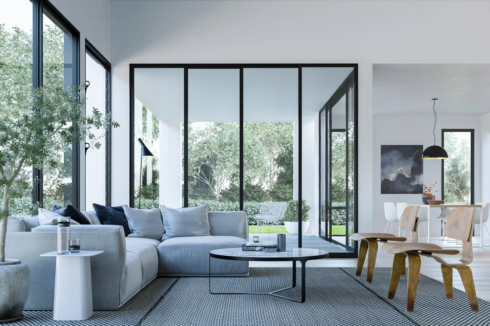 This is an example of a mid-sized contemporary open concept living room in Perth with white walls, light hardwood floors and brown floor.