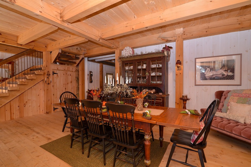 This is an example of a country open plan dining in Toronto with light hardwood floors.