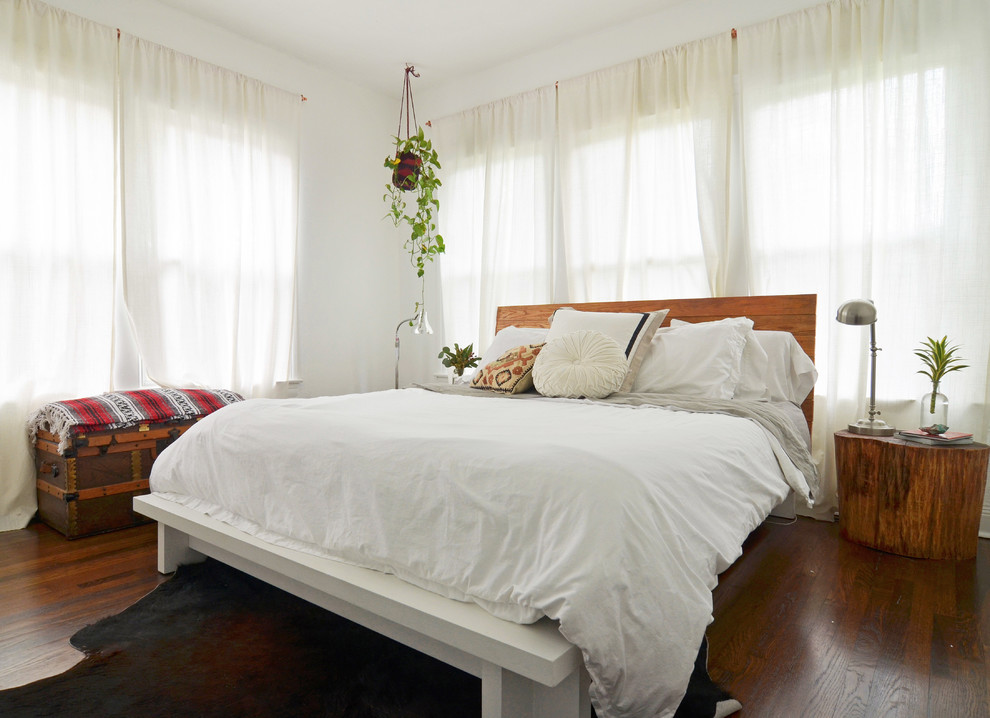 Inspiration for an eclectic bedroom in Dallas with white walls and dark hardwood floors.