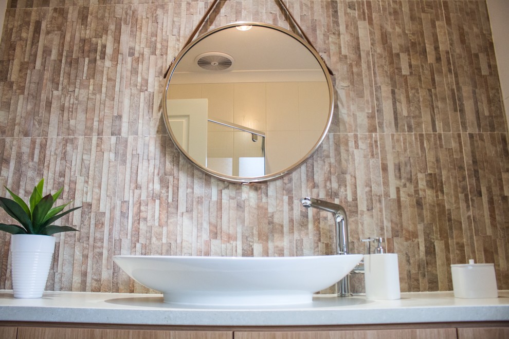 Mid-sized asian master bathroom in Adelaide with furniture-like cabinets, light wood cabinets, a drop-in tub, a corner shower, a one-piece toilet, beige tile, porcelain tile, beige walls, porcelain floors, a vessel sink and laminate benchtops.