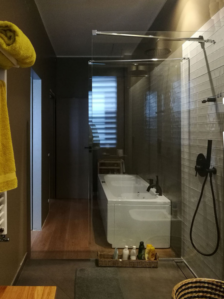 Photo of a 3/4 bathroom in Catania-Palermo with light wood cabinets, a hot tub, a curbless shower, a two-piece toilet, brown tile, ceramic tile, brown walls, ceramic floors, a vessel sink, brown floor, a single vanity and a floating vanity.