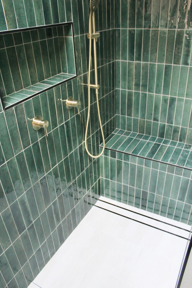 This is an example of a small modern ensuite bathroom in Perth with flat-panel cabinets, light wood cabinets, a walk-in shower, a one-piece toilet, green tiles, matchstick tiles, grey walls, porcelain flooring, a vessel sink, wooden worktops, white floors, an open shower, beige worktops, a shower bench, a single sink and a floating vanity unit.