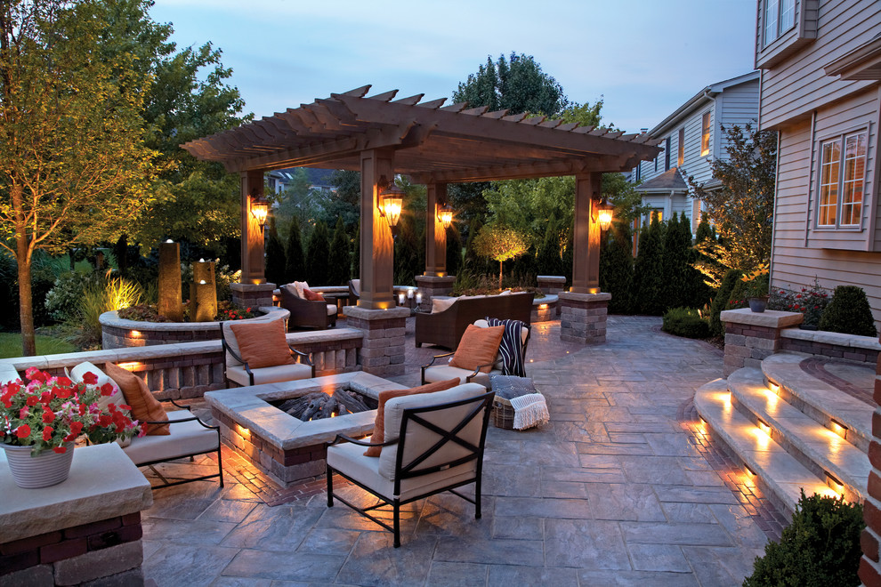 This is an example of a large contemporary backyard patio with a fire feature and a pergola.