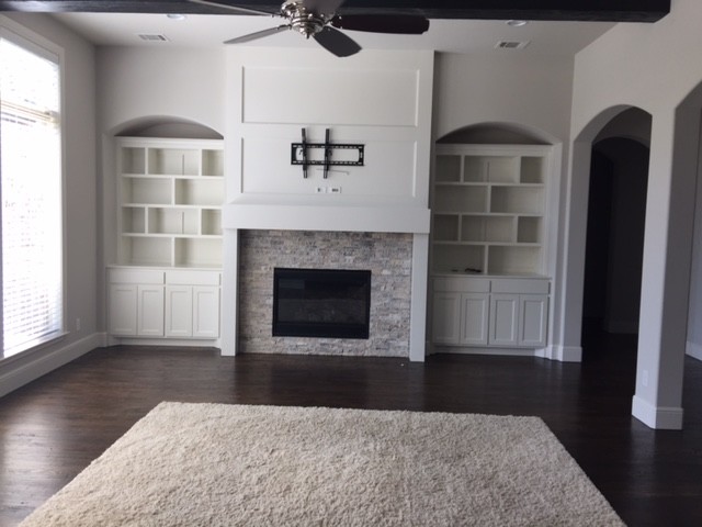 This is an example of a large transitional formal open concept living room in Dallas with white walls, dark hardwood floors, a standard fireplace and a stone fireplace surround.