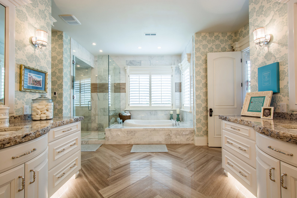 This is an example of a traditional master bathroom in Salt Lake City with an undermount sink, raised-panel cabinets, white cabinets, a corner shower, white tile and multi-coloured walls.
