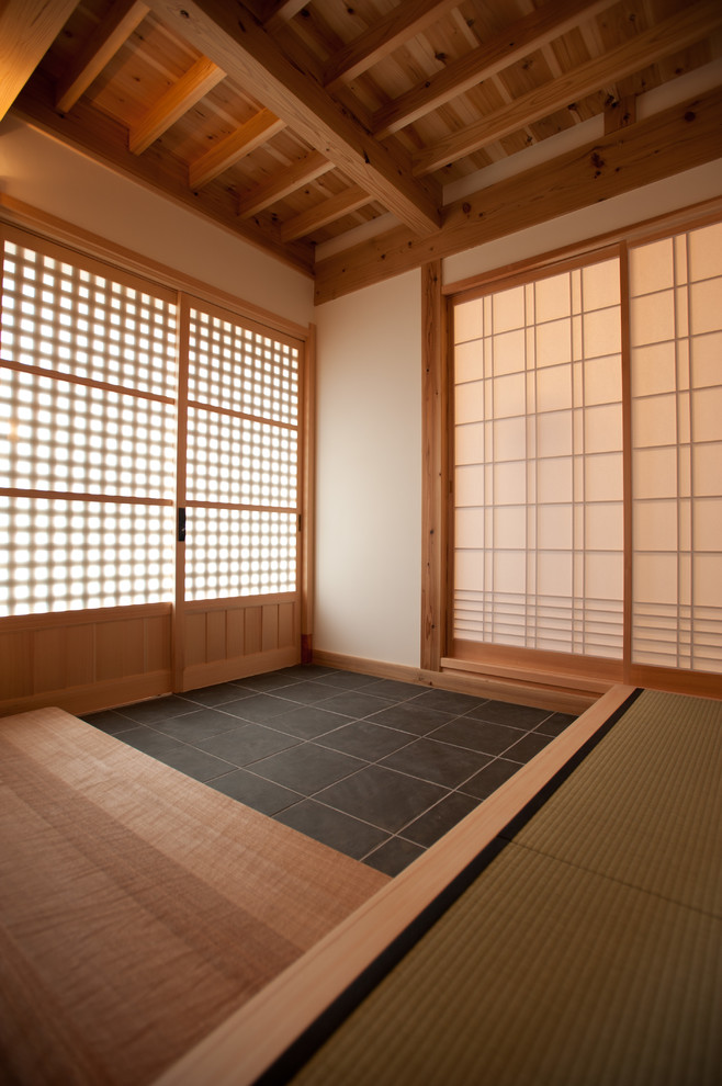 Design ideas for a mid-sized traditional entry hall in Tokyo Suburbs with beige walls, ceramic floors, a sliding front door, a medium wood front door and grey floor.
