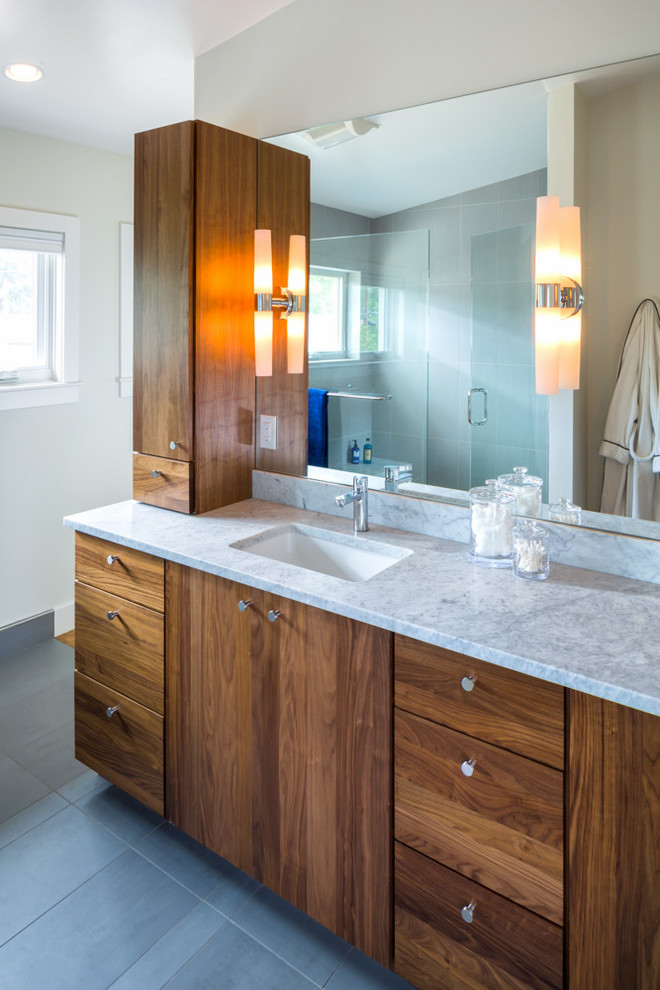 Photo of a modern bathroom in Denver with an undermount sink, flat-panel cabinets, dark wood cabinets, a drop-in tub and white walls.