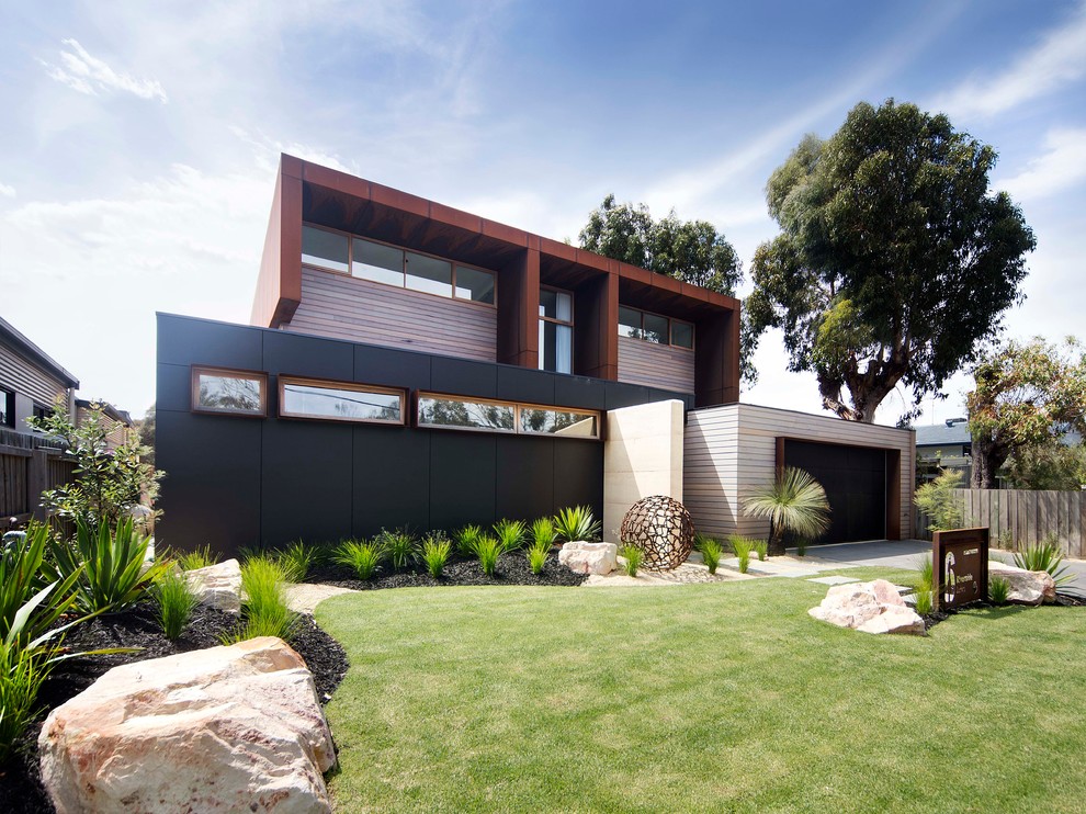 Inspiration for a large contemporary two-storey exterior in Geelong with mixed siding.