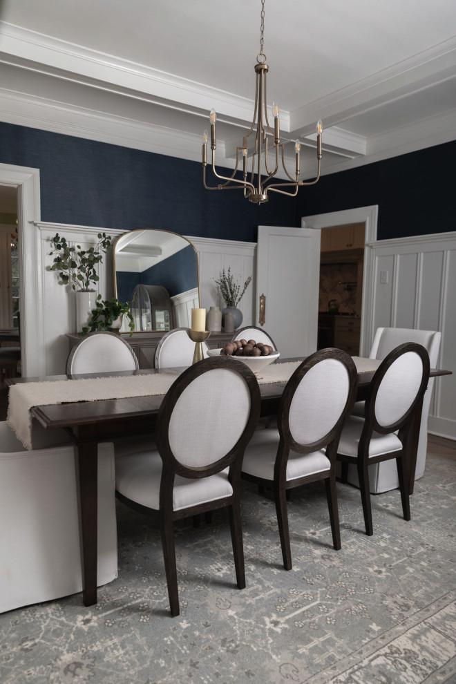 This is an example of a mid-sized transitional open plan dining in New York with blue walls, medium hardwood floors, brown floor, coffered and wallpaper.