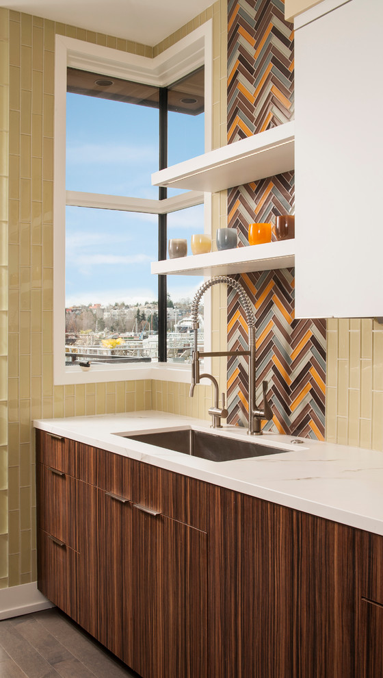 This is an example of a contemporary kitchen in Seattle with an undermount sink, flat-panel cabinets, medium wood cabinets, multi-coloured splashback, mosaic tile splashback and brown floor.