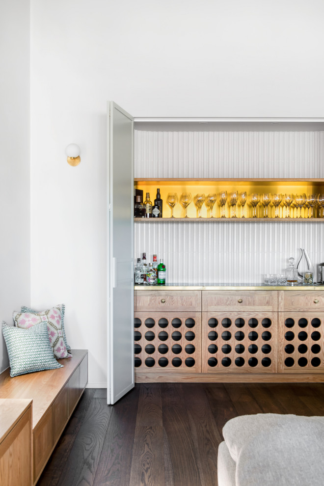 This is an example of a large traditional single-wall home bar in Brisbane with no sink, light wood cabinets, copper benchtops, white splashback, porcelain splashback, dark hardwood floors, brown floor and yellow benchtop.