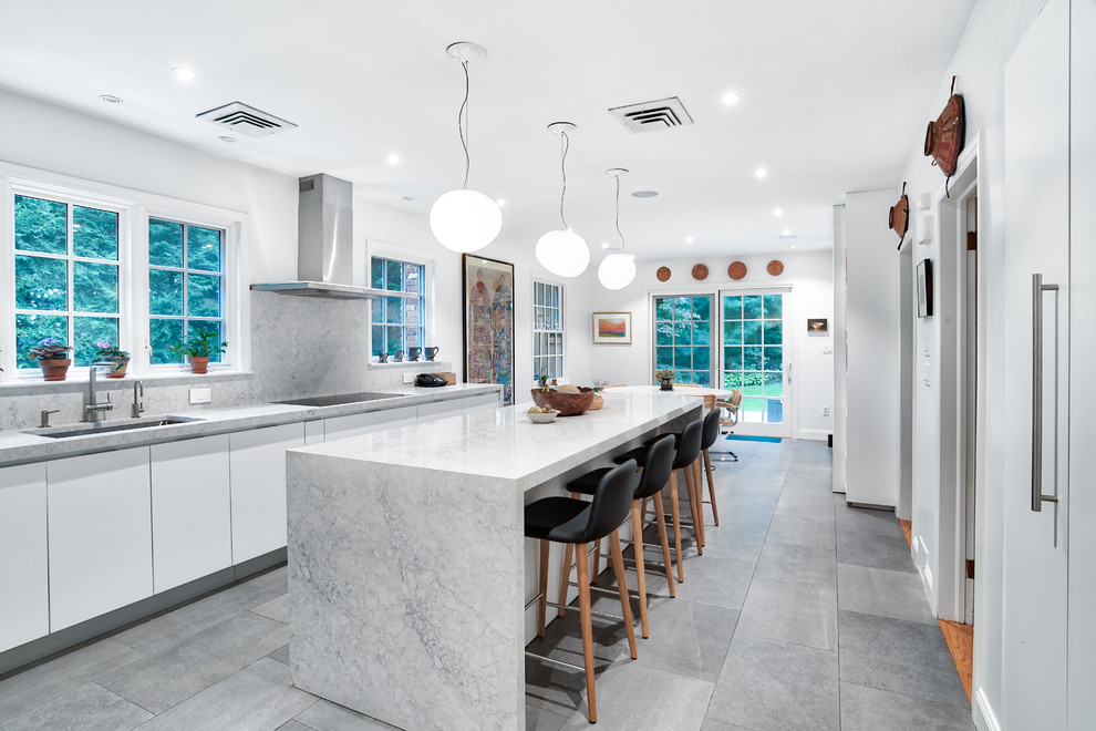 Design ideas for a large modern eat-in kitchen in New York with flat-panel cabinets, white cabinets, quartz benchtops, grey splashback, with island, grey benchtop, an undermount sink and grey floor.