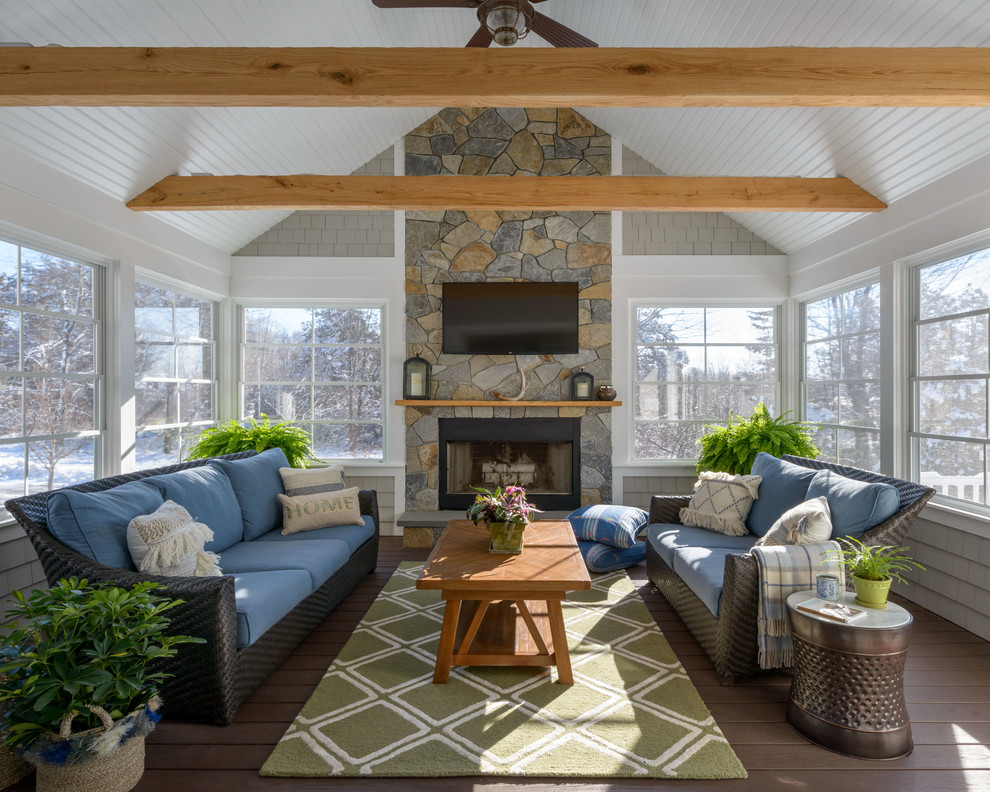 Mid-sized traditional sunroom in Boston with a standard fireplace, a stone fireplace surround, a standard ceiling, dark hardwood floors and brown floor.