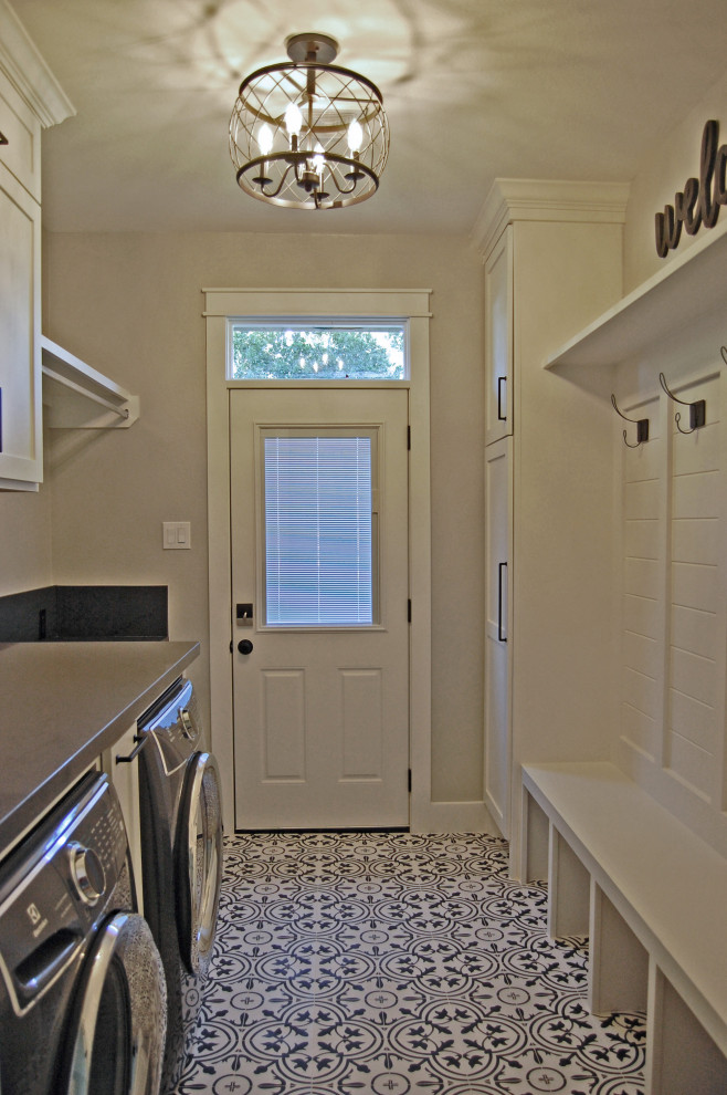 Inspiration for a mid-sized country galley utility room in Houston with shaker cabinets, white cabinets, quartz benchtops, grey walls, ceramic floors, an integrated washer and dryer, white floor and grey benchtop.