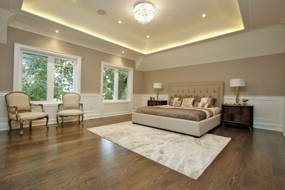 Photo of a large transitional master bedroom in Toronto with beige walls, dark hardwood floors and brown floor.
