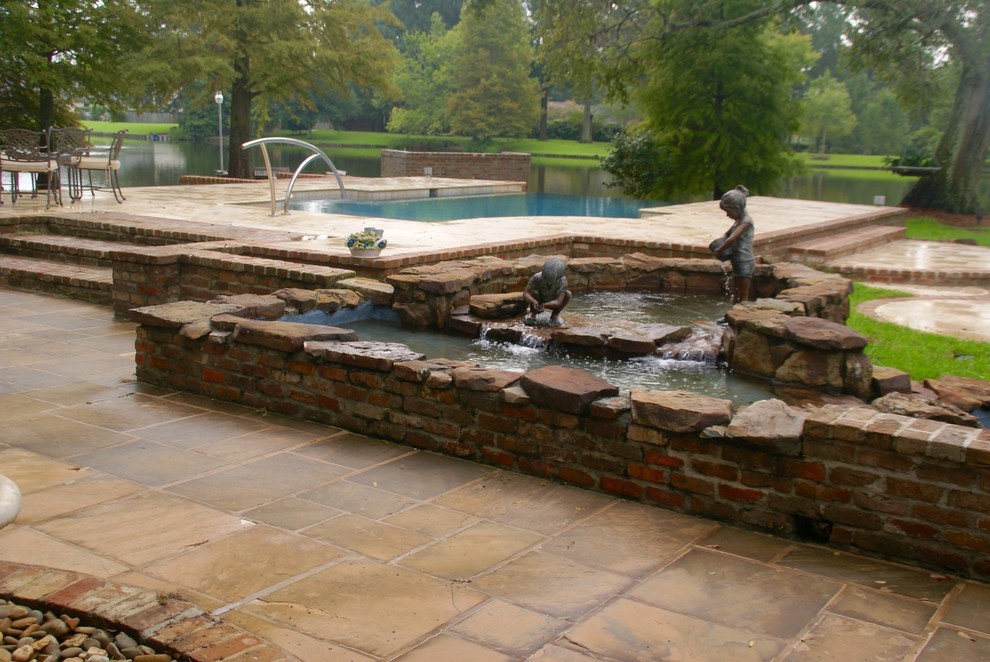 Pool fountain - large transitional backyard stone and custom-shaped infinity pool fountain idea