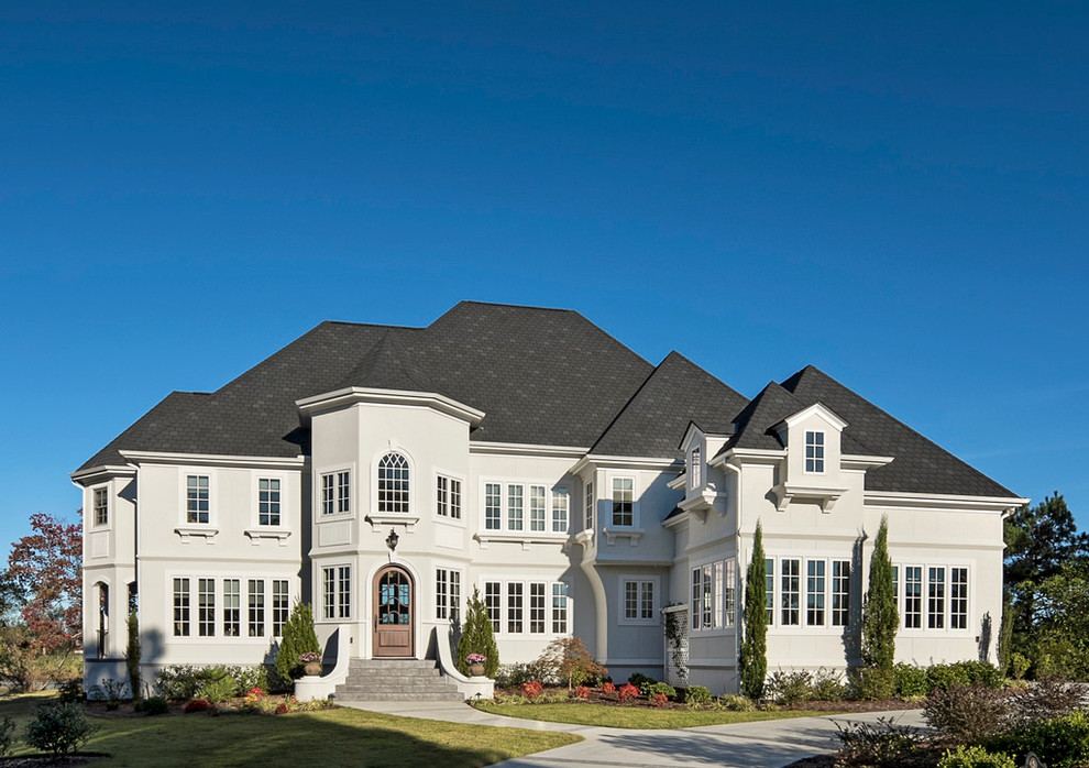 Inspiration for a large traditional two-storey stucco white exterior in Wilmington with a hip roof.