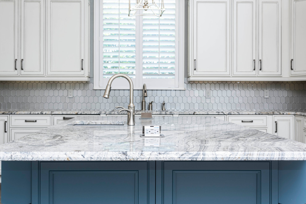 Kitchen - large transitional u-shaped laminate floor and multicolored floor kitchen idea in Orlando with an undermount sink, recessed-panel cabinets, white cabinets, granite countertops, metallic backsplash, glass tile backsplash, paneled appliances, an island and gray countertops