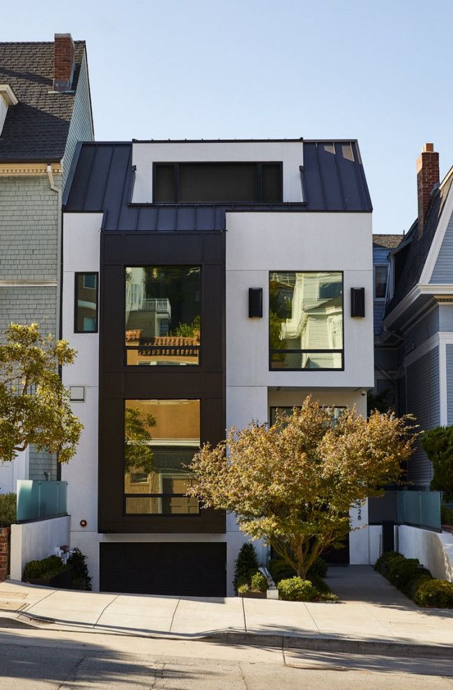 Medium sized and white contemporary house exterior in San Francisco with three floors and a half-hip roof.