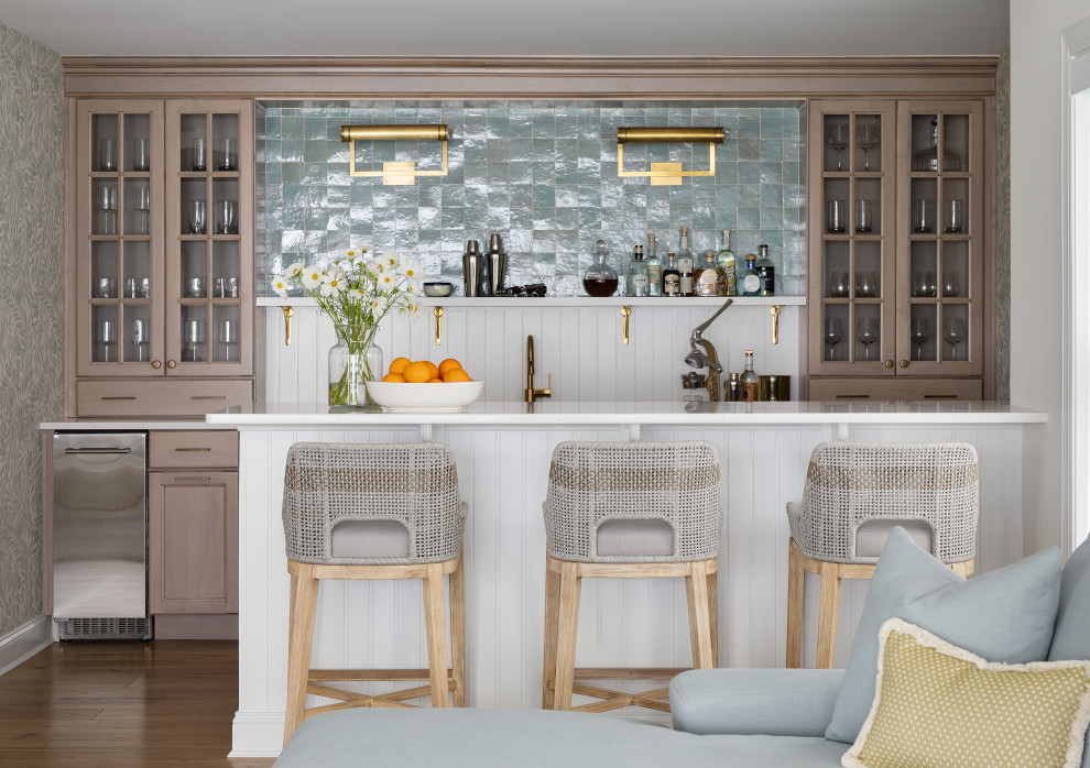 Design ideas for a beach style wet bar in Other with light wood cabinets, blue splashback, cement tile splashback, light hardwood floors and white benchtop.