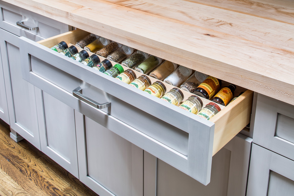 Inspiration for a transitional medium tone wood floor kitchen remodel in Atlanta with wood countertops, green backsplash and an island