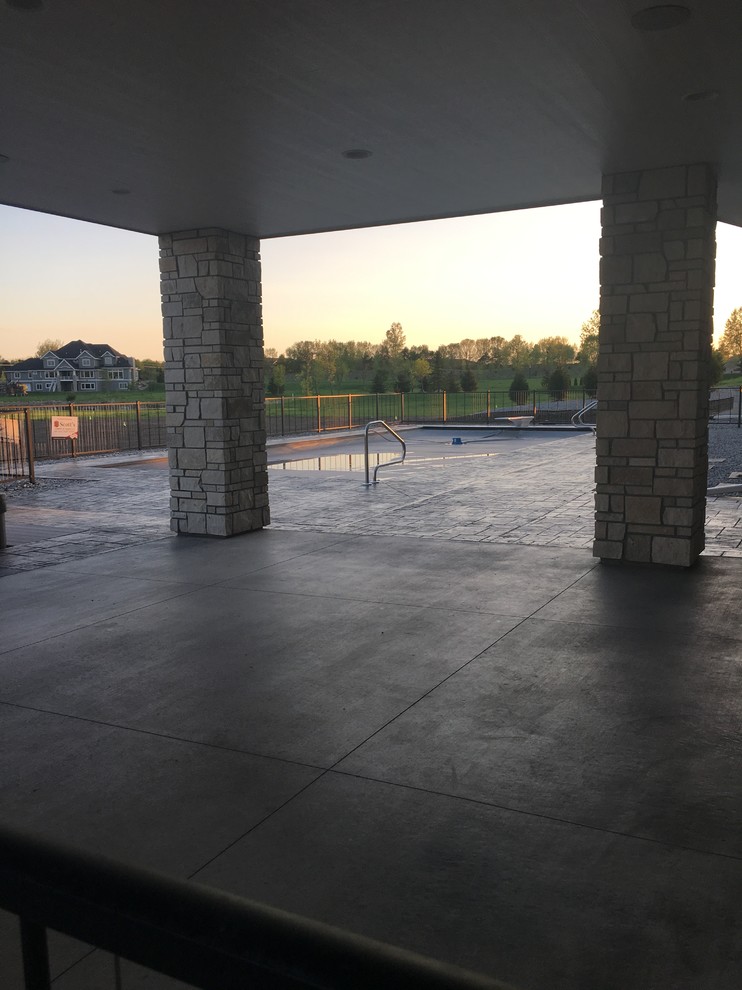 Large transitional backyard stamped concrete and rectangular hot tub photo