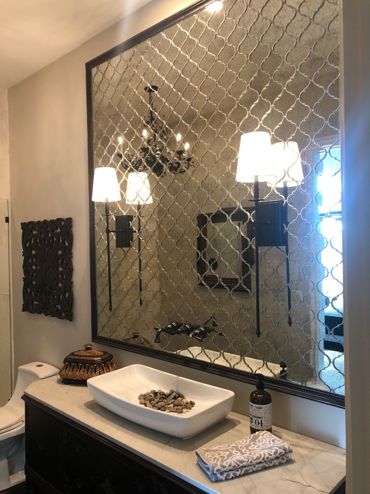 Photo of a mid-sized transitional bathroom in San Diego with furniture-like cabinets, dark wood cabinets, an open shower, a one-piece toilet, mirror tile, beige walls, dark hardwood floors, a vessel sink, quartzite benchtops, brown floor, an open shower and white benchtops.