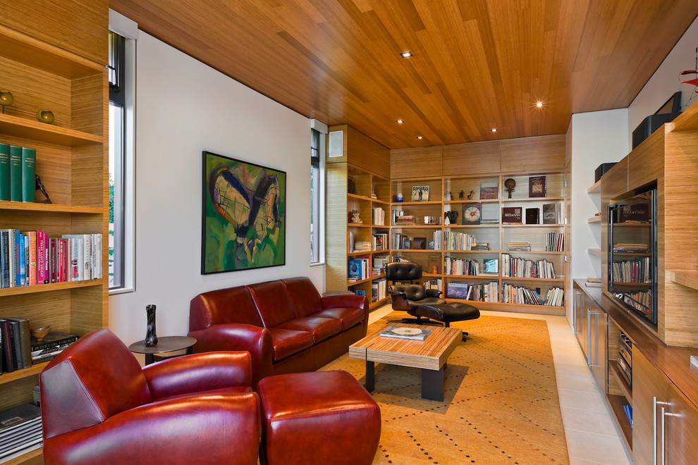 Contemporary family room in Santa Barbara with a library and white walls.