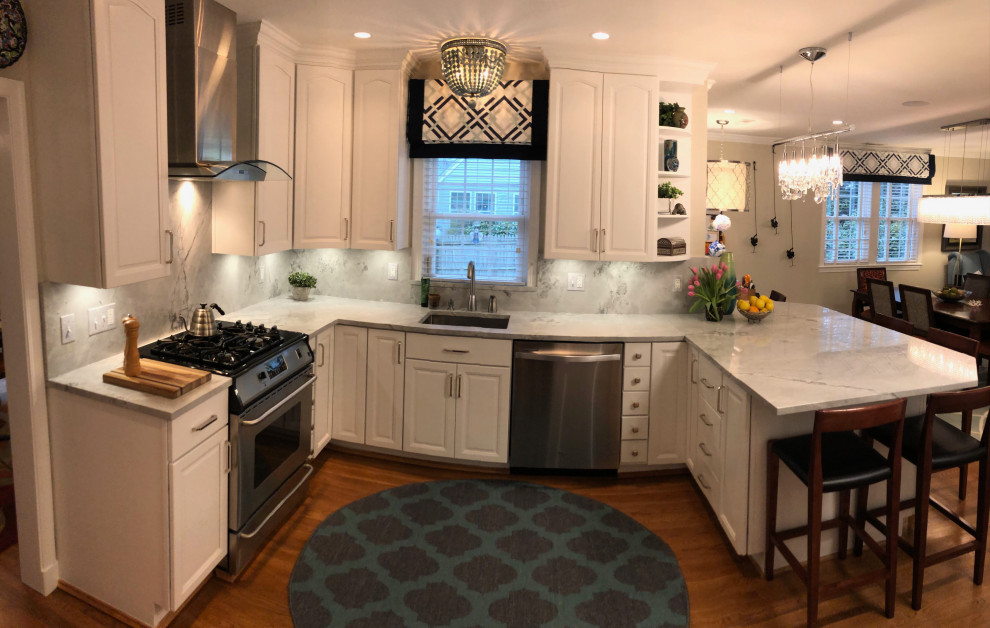 Inspiration for a mid-sized transitional u-shaped medium tone wood floor and brown floor eat-in kitchen remodel in DC Metro with an undermount sink, recessed-panel cabinets, white cabinets, quartzite countertops, white backsplash, quartz backsplash, stainless steel appliances, an island and white countertops