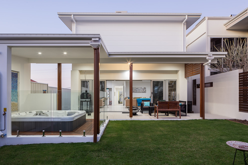 Design ideas for a large contemporary three-storey white exterior in Brisbane with mixed siding.