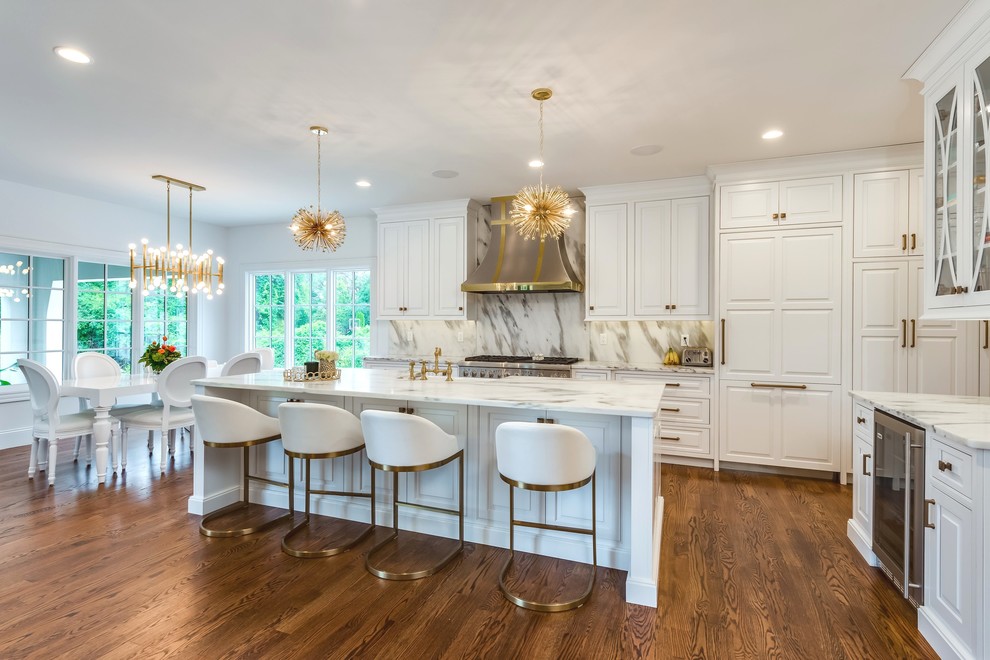 Inspiration for a transitional eat-in kitchen in St Louis with a farmhouse sink, beaded inset cabinets, white cabinets, marble benchtops, white splashback, stainless steel appliances, medium hardwood floors, with island and marble splashback.