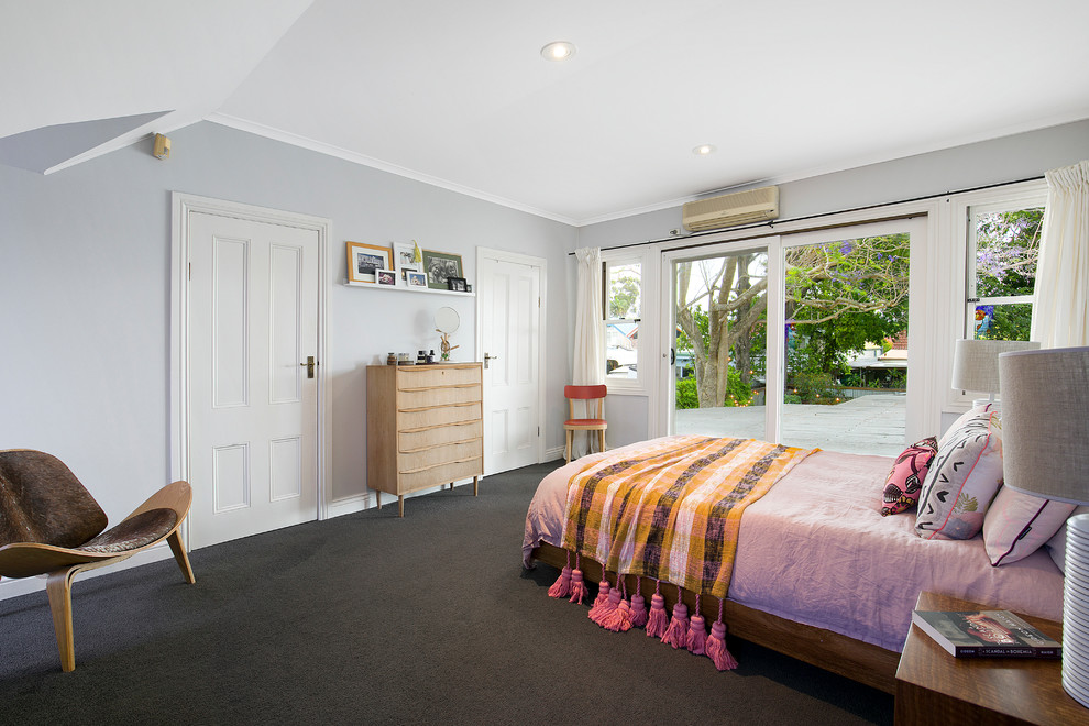 Large transitional master bedroom in Sydney with carpet, no fireplace, grey walls and grey floor.