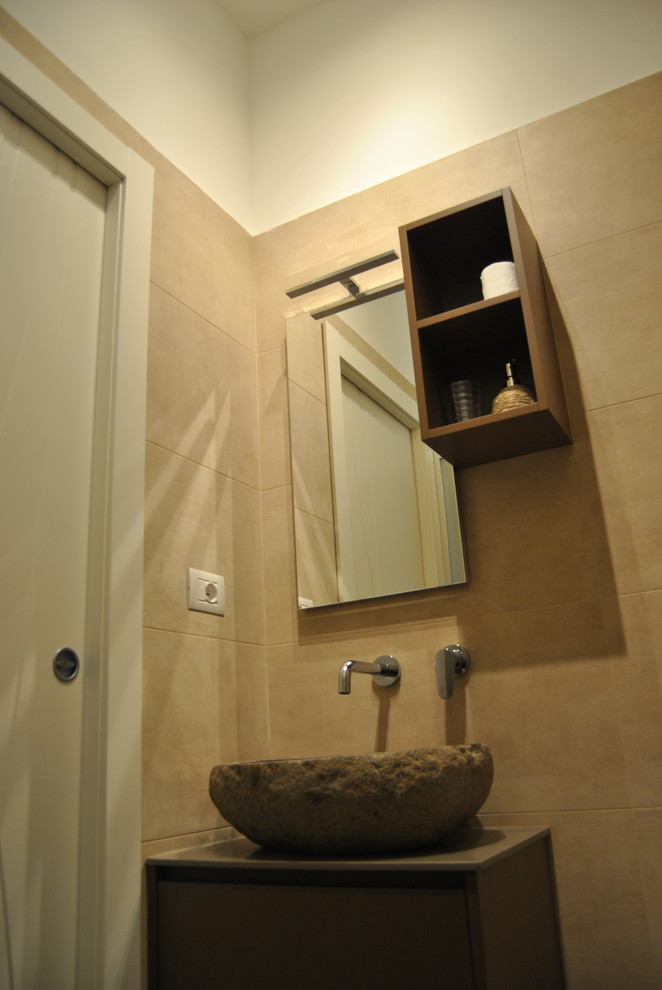 Inspiration for a small contemporary powder room in Milan with flat-panel cabinets, dark wood cabinets, a wall-mount toilet, ceramic tile, ceramic floors, a vessel sink, solid surface benchtops, brown floor and grey benchtops.