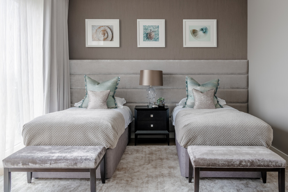 Photo of a large contemporary guest bedroom in London with no fireplace and grey walls.