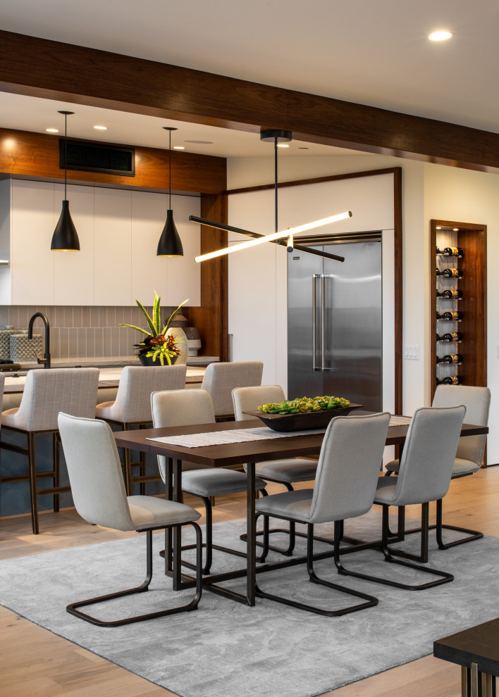 Design ideas for a mid-sized contemporary open plan dining in San Diego with white walls, light hardwood floors, no fireplace and beige floor.