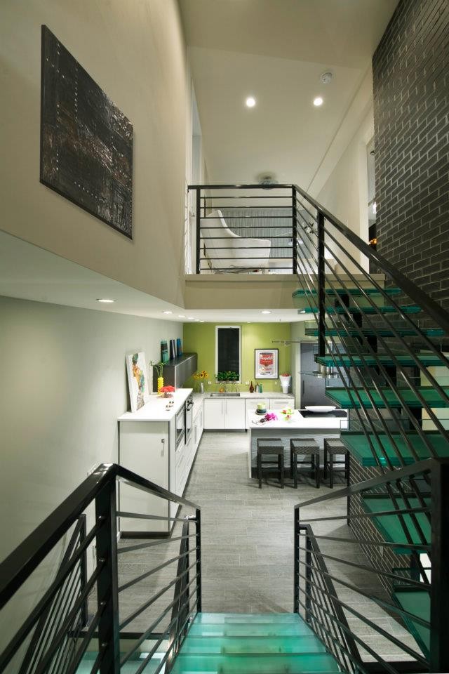 Mid-sized modern glass u-shaped staircase in Denver with open risers and metal railing.