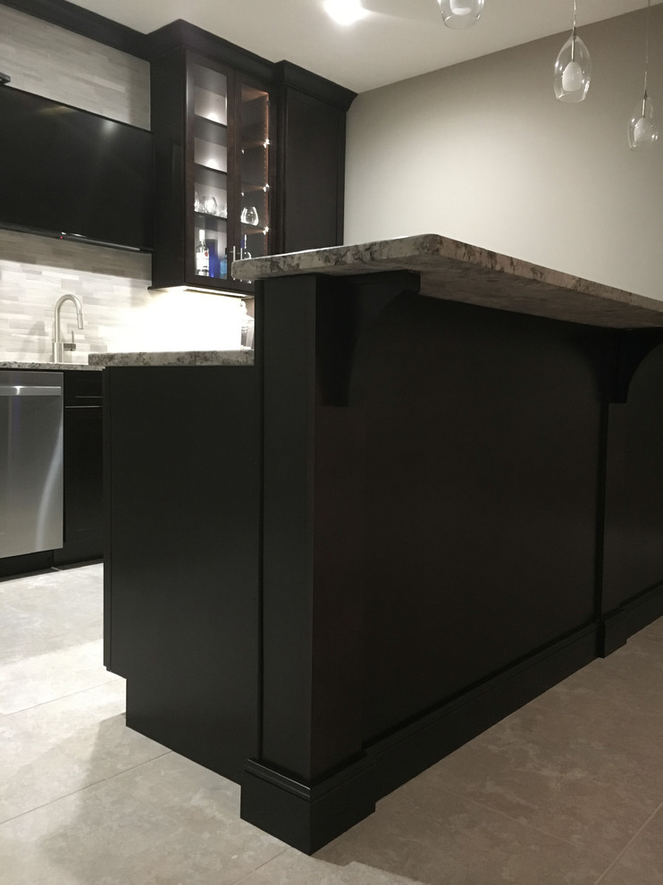 Large modern single-wall seated home bar in Other with an undermount sink, shaker cabinets, dark wood cabinets, granite benchtops, grey splashback, mosaic tile splashback, porcelain floors and grey floor.