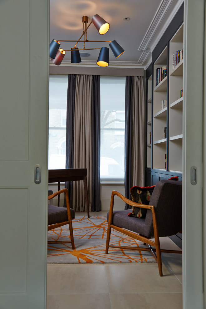 Photo of a mid-sized contemporary study room in Other with beige walls, terra-cotta floors and a freestanding desk.