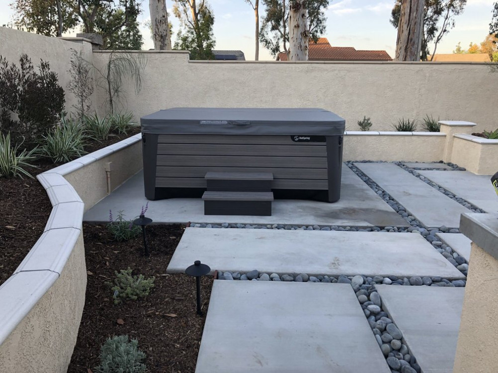 This is an example of a traditional backyard patio in Orange County with concrete pavers.