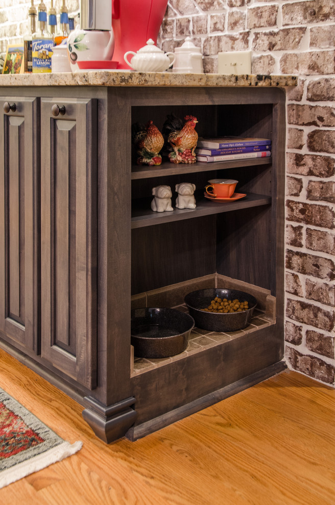 Inspiration for a large transitional u-shaped medium tone wood floor eat-in kitchen remodel in Raleigh with a farmhouse sink, raised-panel cabinets, beige cabinets, granite countertops, multicolored backsplash, stainless steel appliances and a peninsula