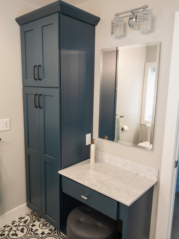 Inspiration for a mid-sized transitional l-shaped medium tone wood floor and brown floor eat-in kitchen remodel with an undermount sink, flat-panel cabinets, light wood cabinets, quartz countertops, yellow backsplash, subway tile backsplash, stainless steel appliances, an island and white countertops