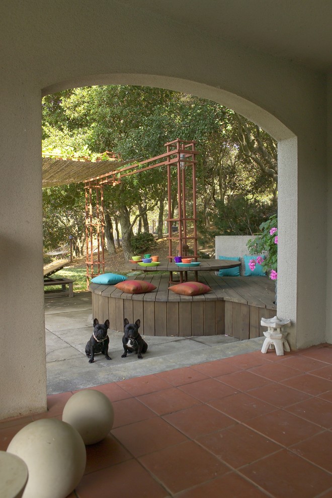 This is an example of an expansive mediterranean backyard deck in San Francisco with a pergola.