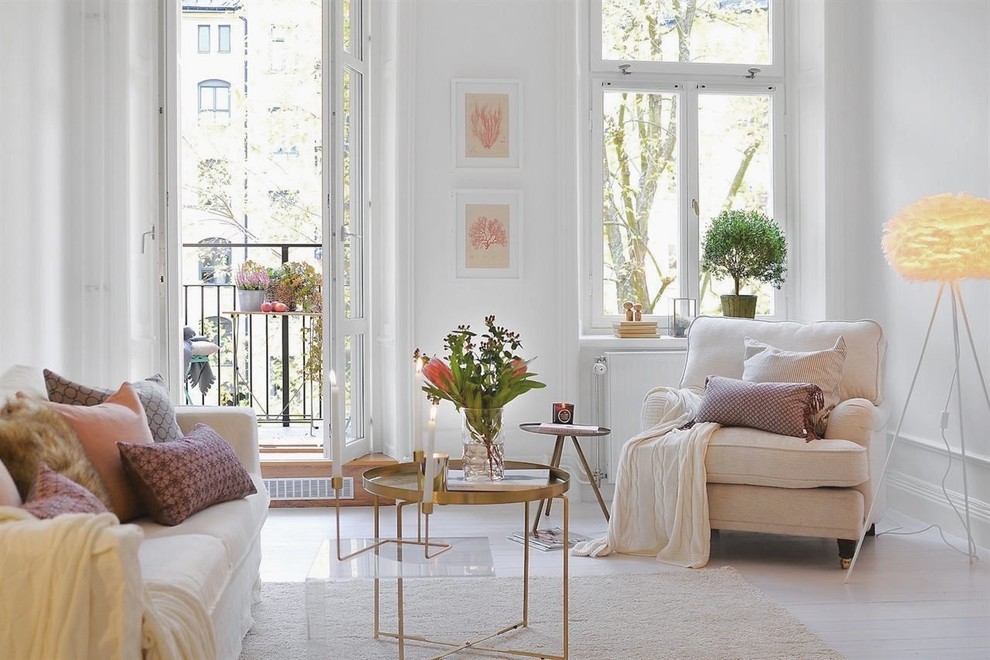Photo of a large scandinavian formal enclosed living room in Stockholm with white walls, painted wood floors, no fireplace and no tv.