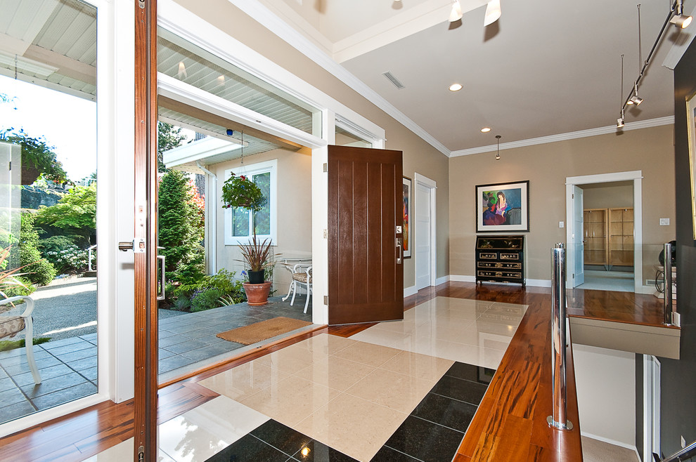 Inspiration for a large transitional porcelain tile and multicolored floor entry hall remodel with beige walls and a dark wood front door