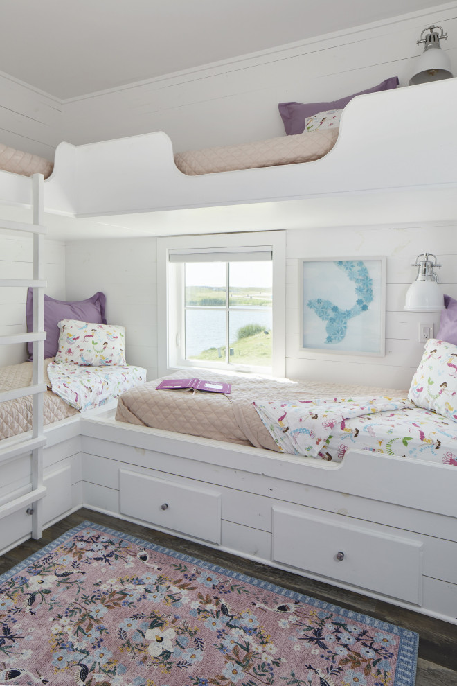 Design ideas for a mid-sized beach style kids' bedroom for girls in Other with white walls, vinyl floors, brown floor and planked wall panelling.