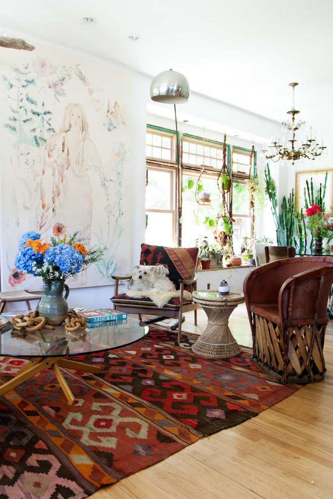 Inspiration for a mid-sized eclectic open concept medium tone wood floor living room remodel in Seattle with white walls